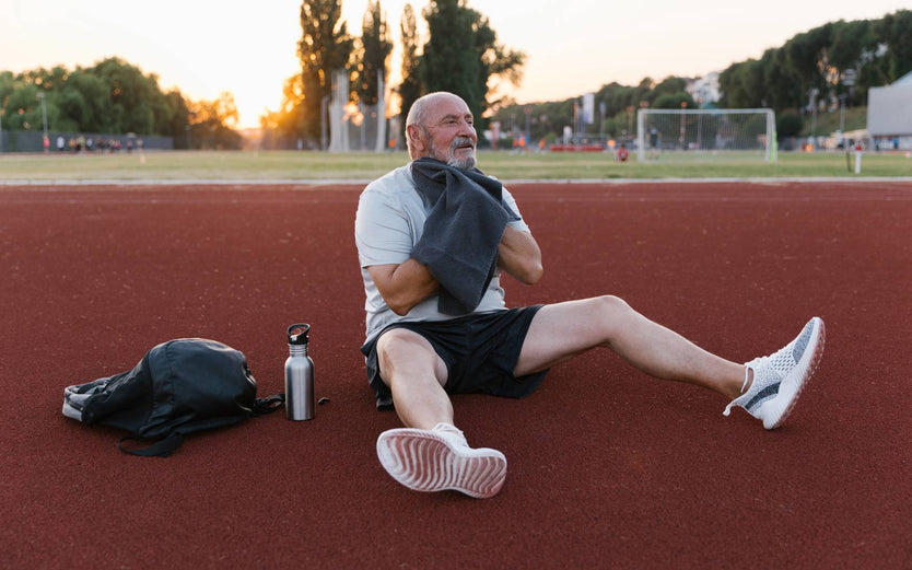 Man sitting on a running track after a workout