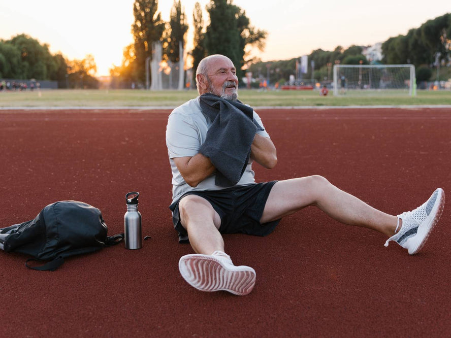 Man sitting on a running track after a workout
