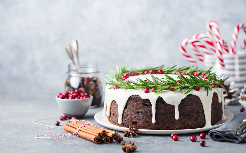 Christmas Cake on a table with spices and berries