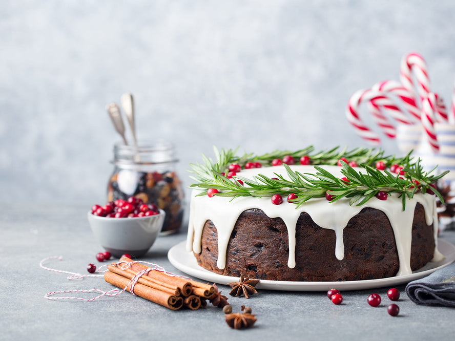 Christmas Cake on a table with spices and berries