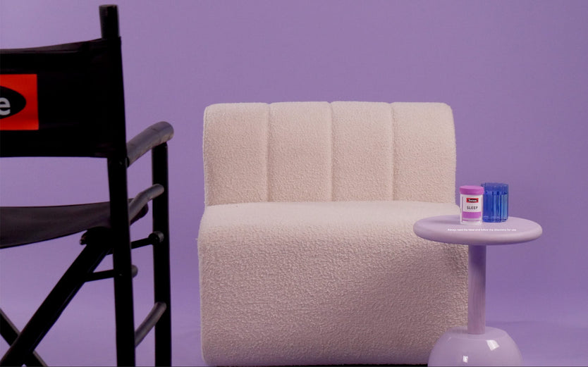 White chair with a Swisse product on a sidetable and a director's chair facing it.