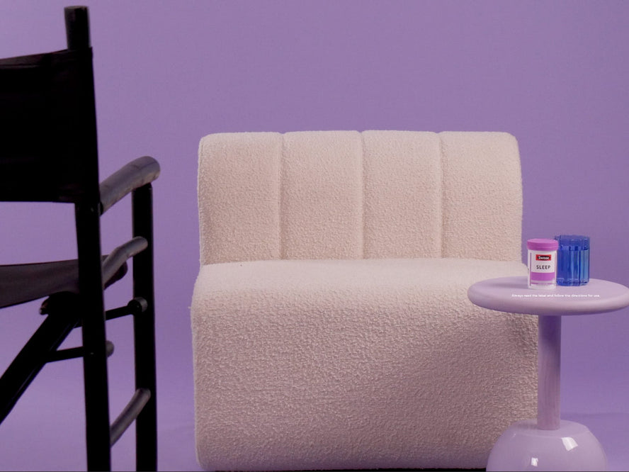 White chair with a Swisse product on a sidetable and a director's chair facing it.