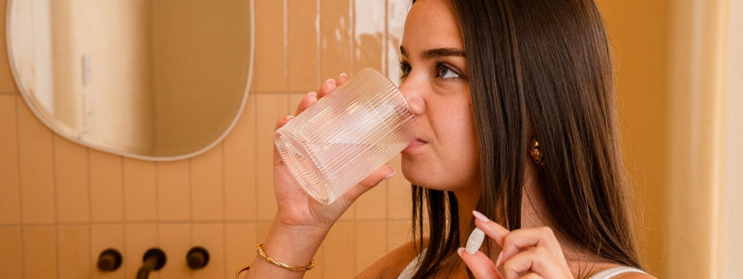 Person drink water holding a tablet