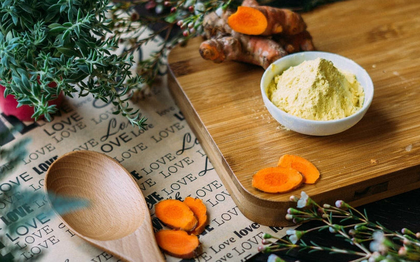 Tumeric in a bowl on a wooden board