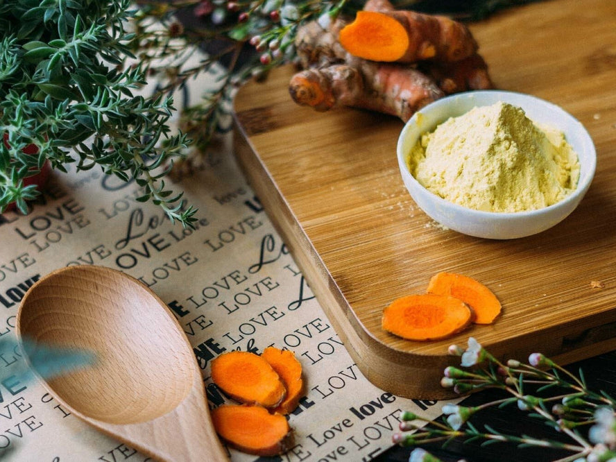 Tumeric in a bowl on a wooden board