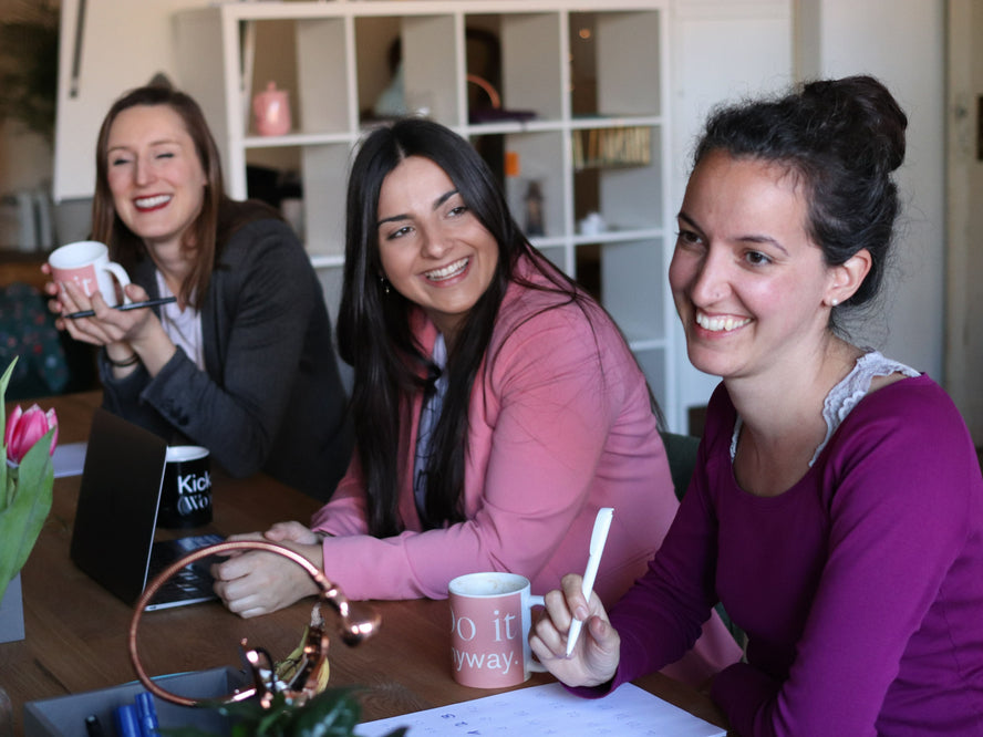 Young women sitting in cafe talking