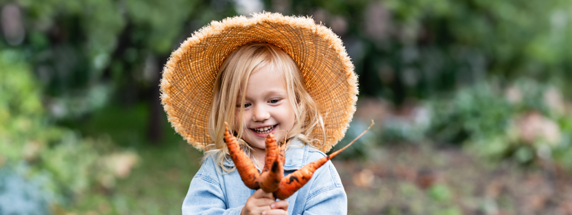 Child holding carrots