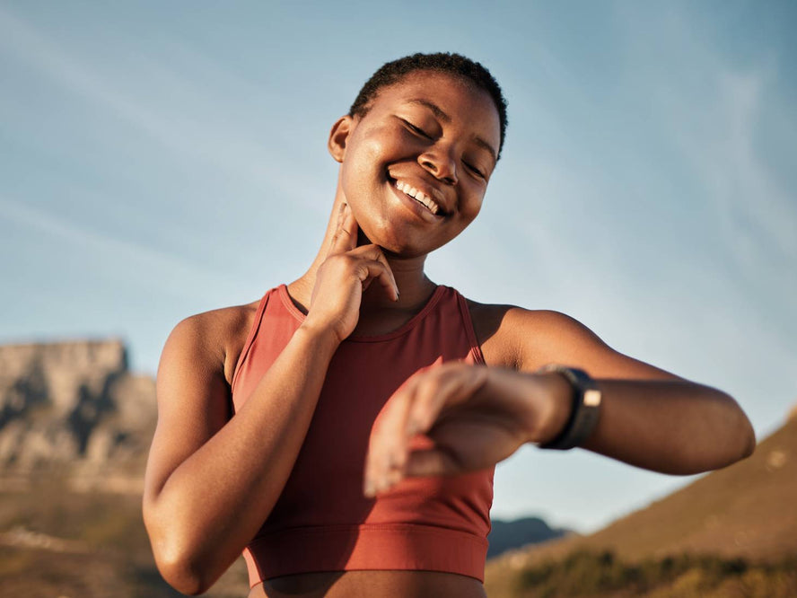 Person checking their pulse and smart watch
