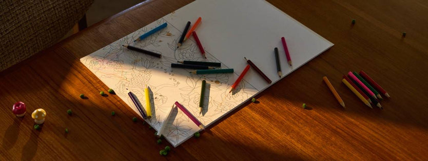 Table top with paper and crayons