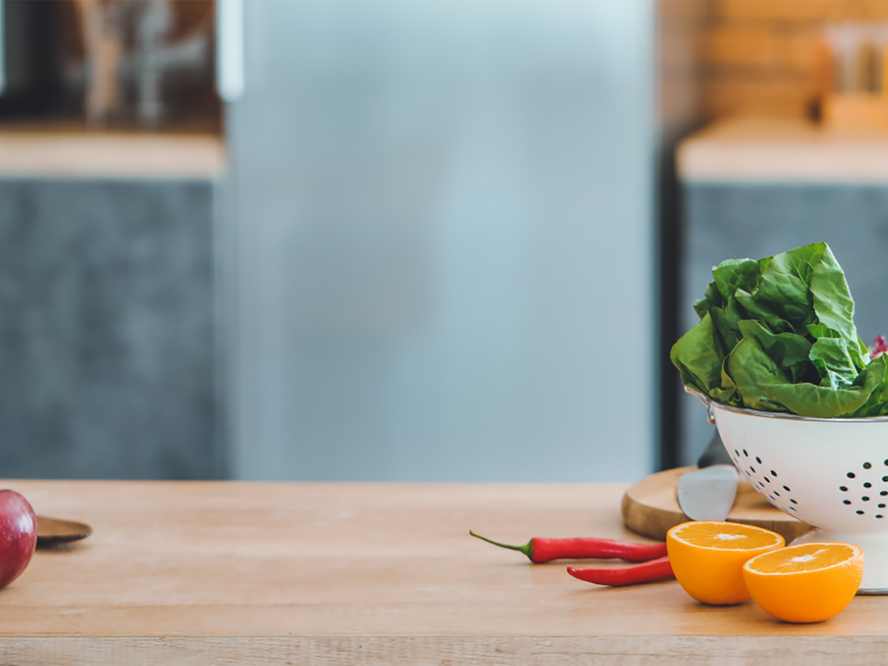 Fresh fruit and veg on a wooden kitchen bench