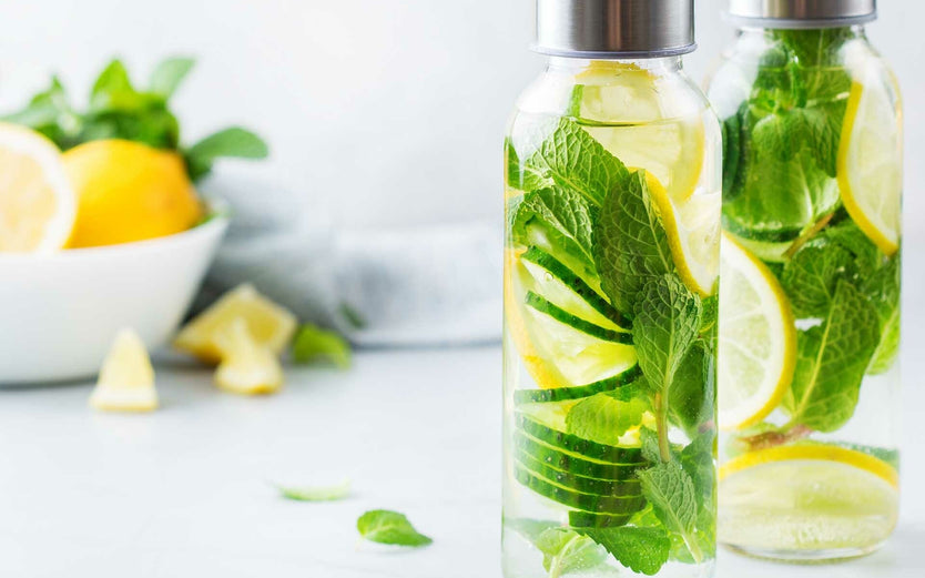 Bottles of water infused with lemons and herbs