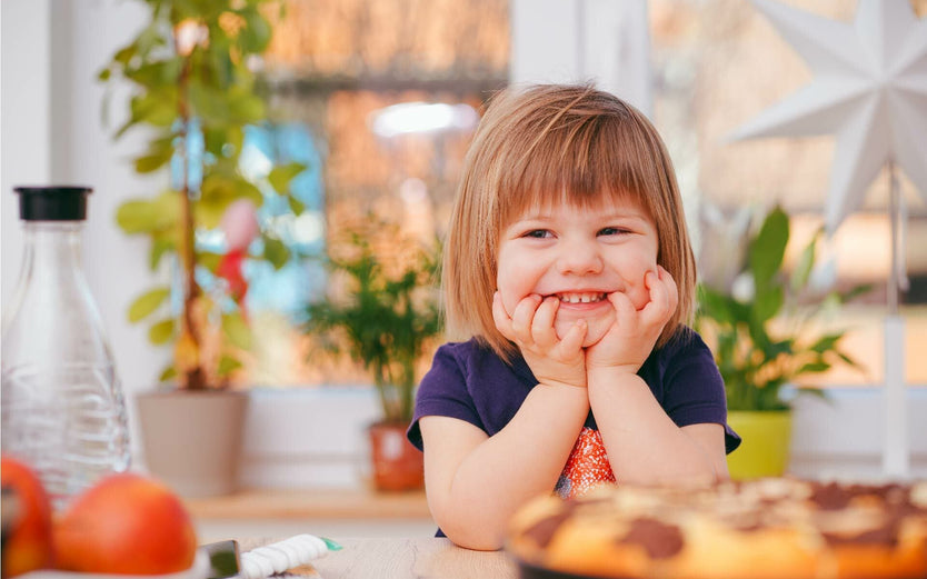 Child sat at table with food