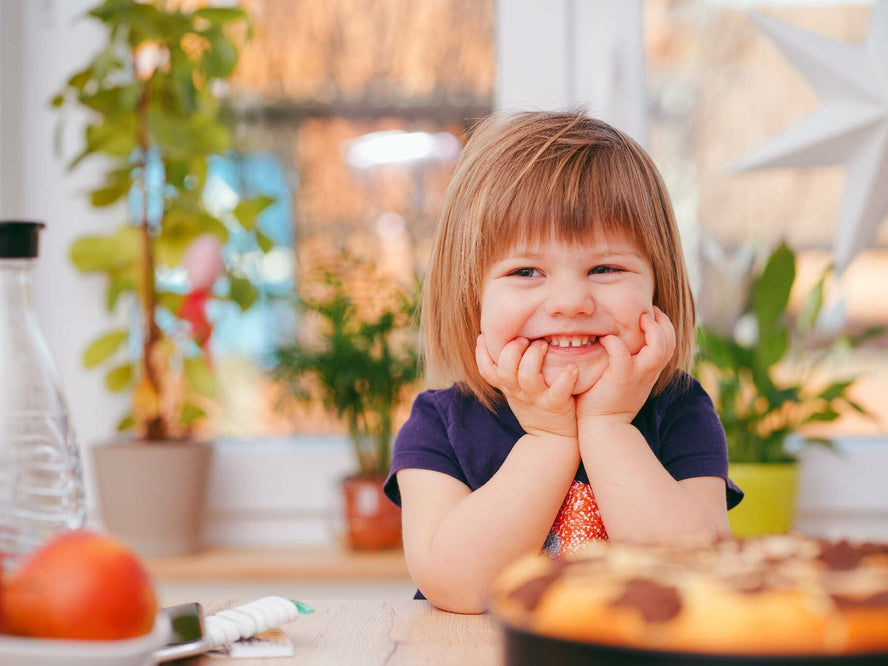 Child sat at table with food