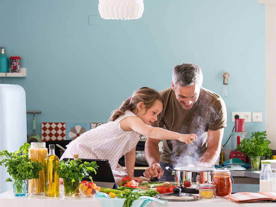 Child cooking with grownup