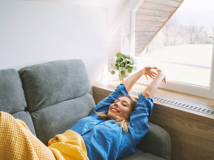 Person stretching after a sleep on the couch