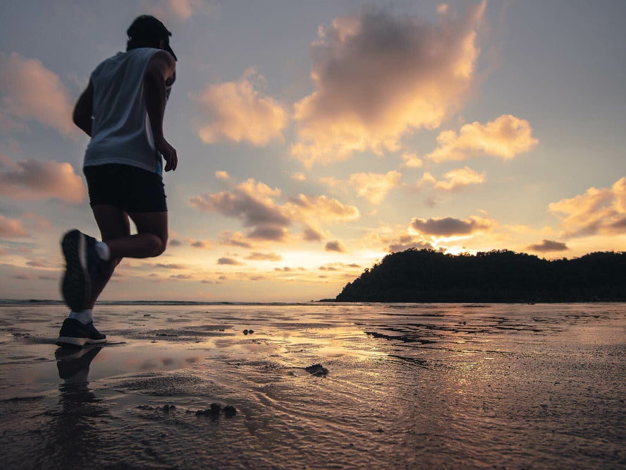 Man running at daylight savings on beach
