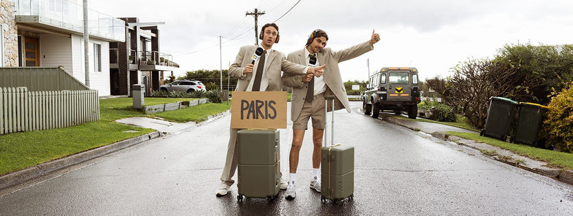 The Inspired Unemployed Standing With Suitcases And A Paris Sign