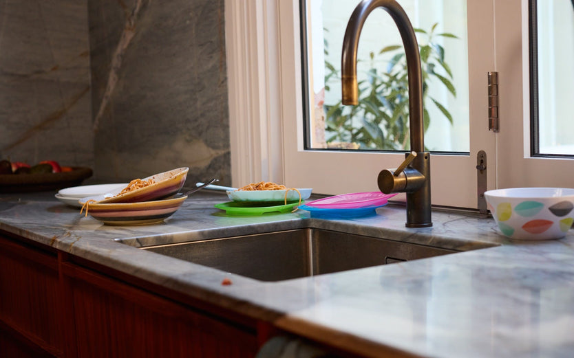 Dirty dishes next to a kitchen sink