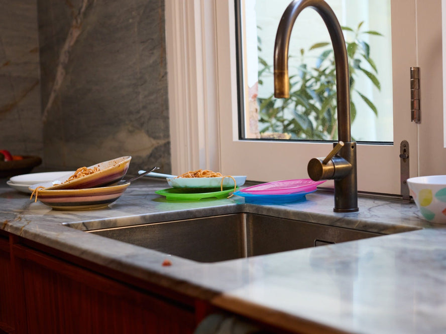 Dirty dishes next to a kitchen sink