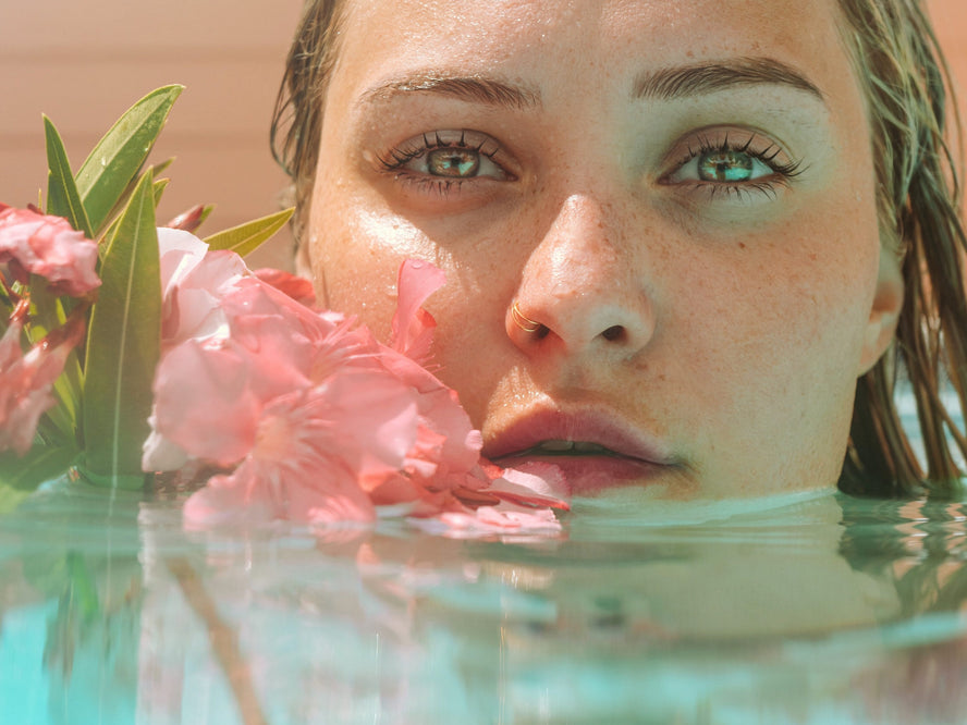 Woman in water with flower