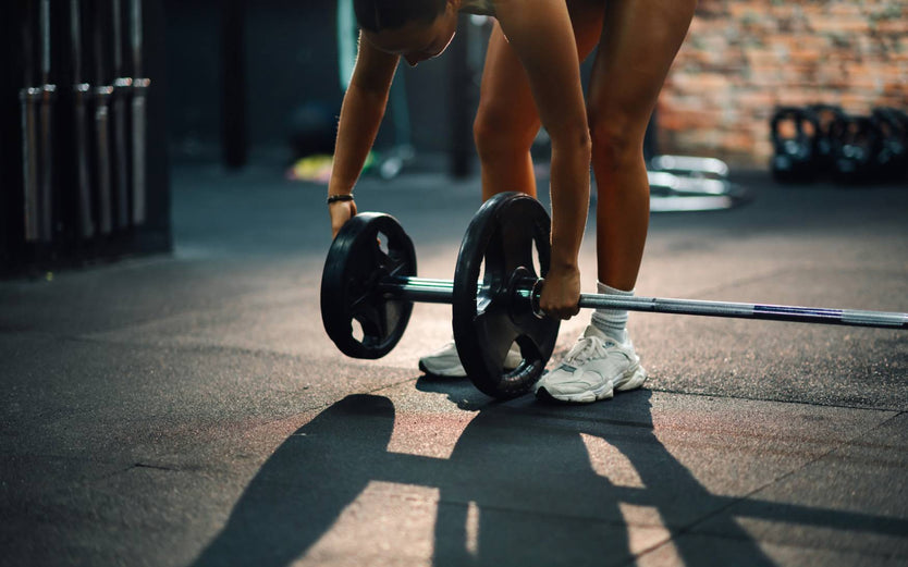 Person adding weights onto a barbell
