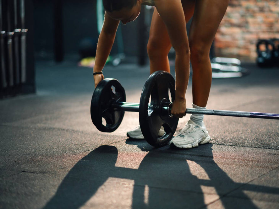 Person adding weights onto a barbell
