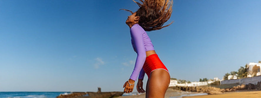Women on the beach flicking her hair