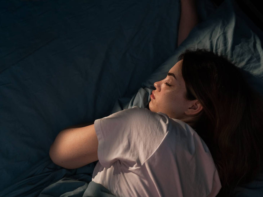 Person sleeping in a dark room