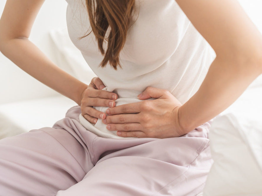 Woman clutching her abdomen in discomfort
