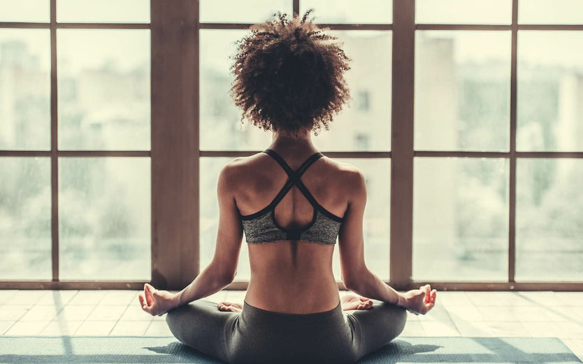 Woman meditating in yoga studio
