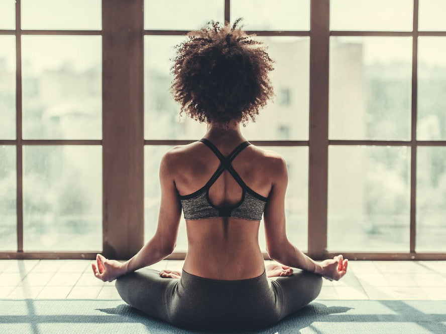 Woman meditating in yoga studio