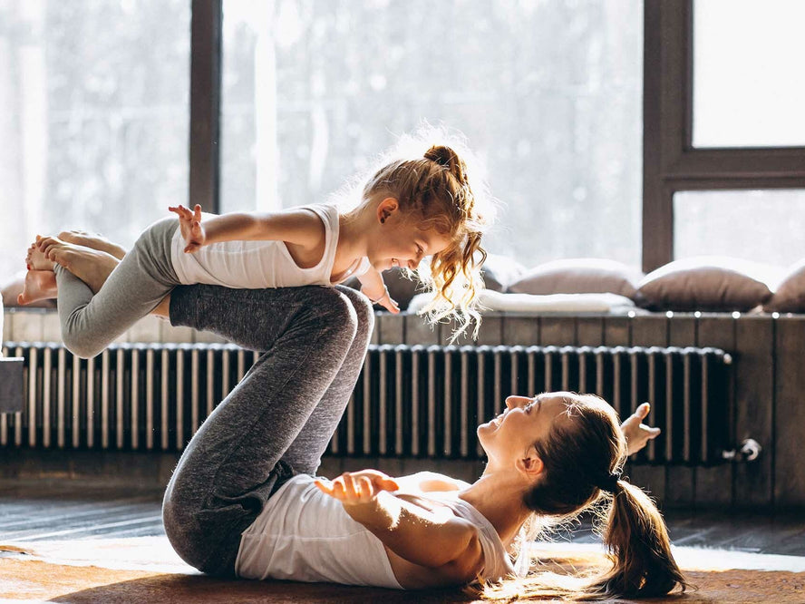 Mum and child doing yoga together