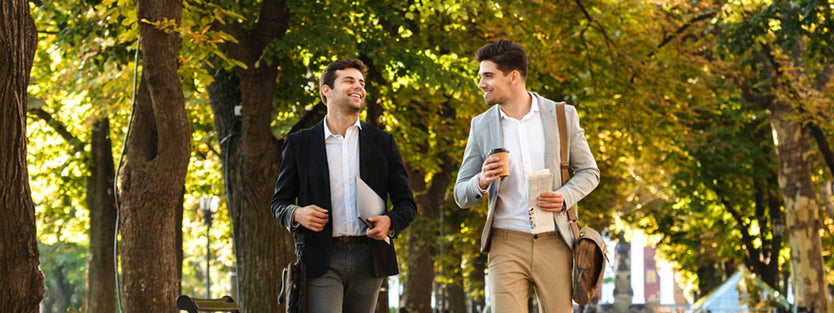 Males wearing business attire walking in a park