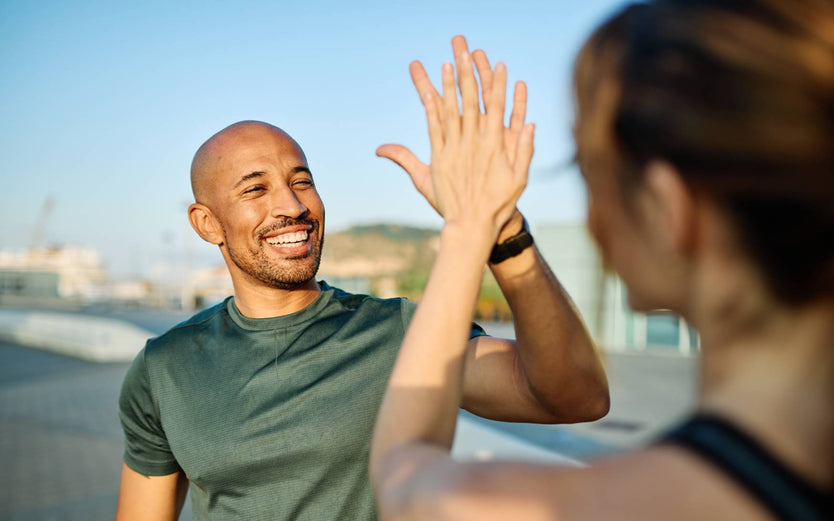 People high fiving after a run