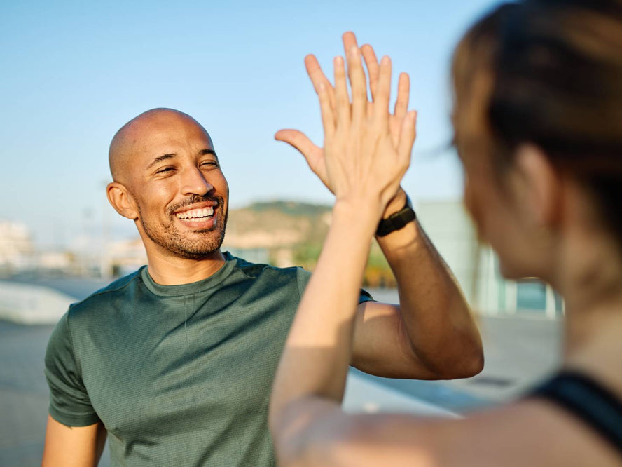 People high fiving after a run
