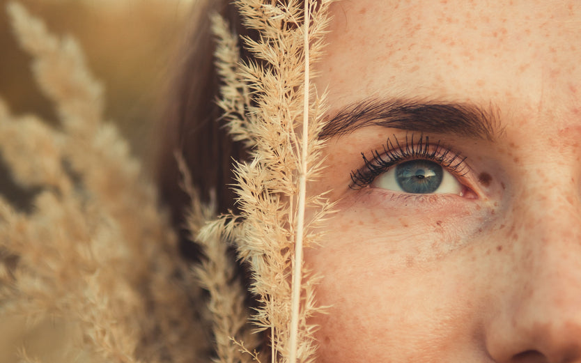 Close up of woman's face in a plant field