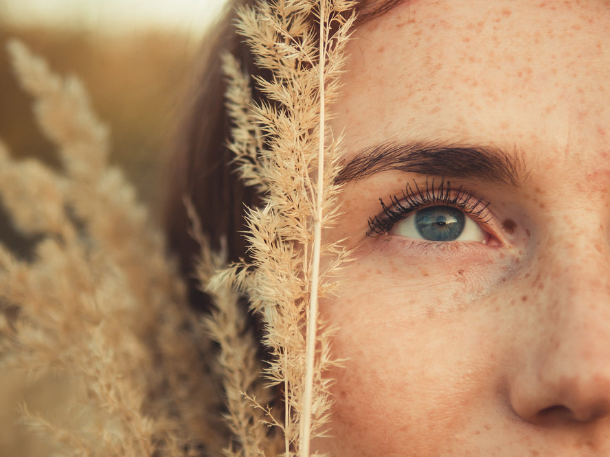 Close up of woman's face in a plant field
