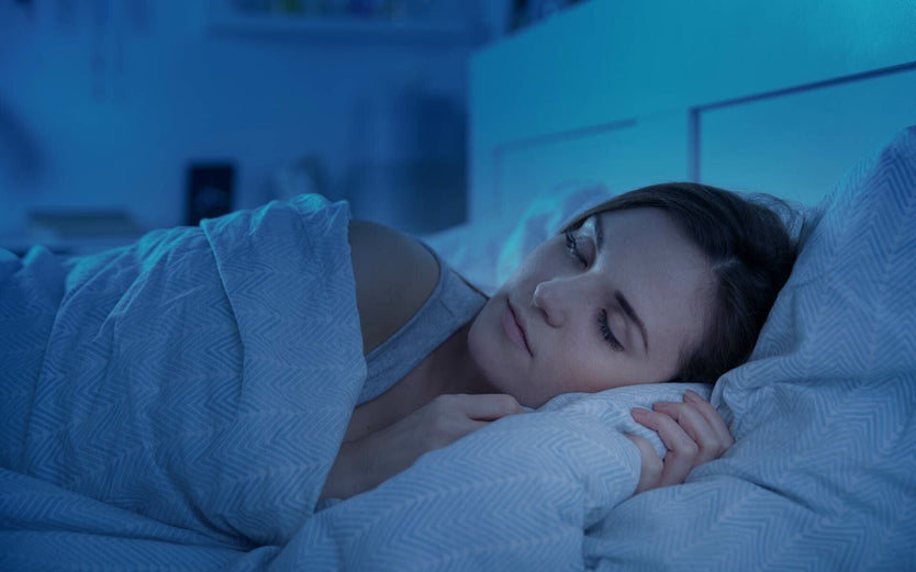 Woman sleeping in bed at night