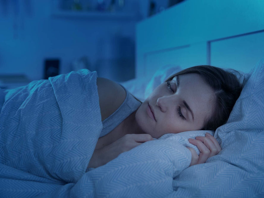 Woman sleeping in bed at night