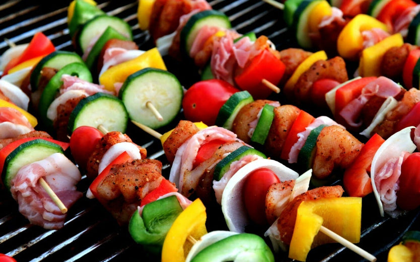 Meat and vegetable kebabs on a grill