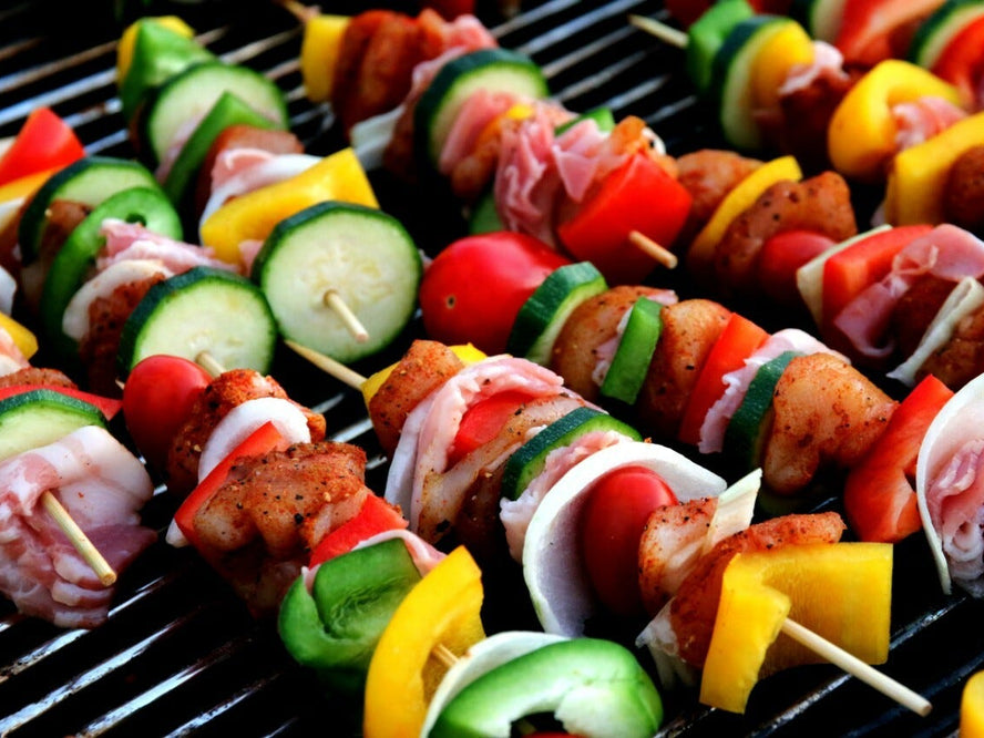 Meat and vegetable kebabs on a grill