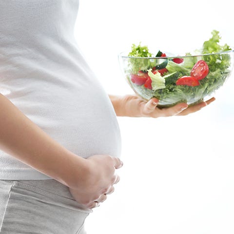 Pregnant belly and a bowl of salad