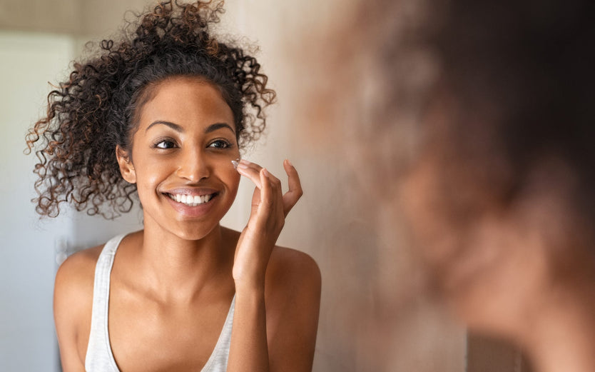 Picture of woman doing skincare in mirror