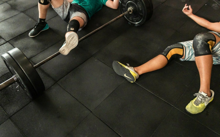 People laying on the floor of a gym