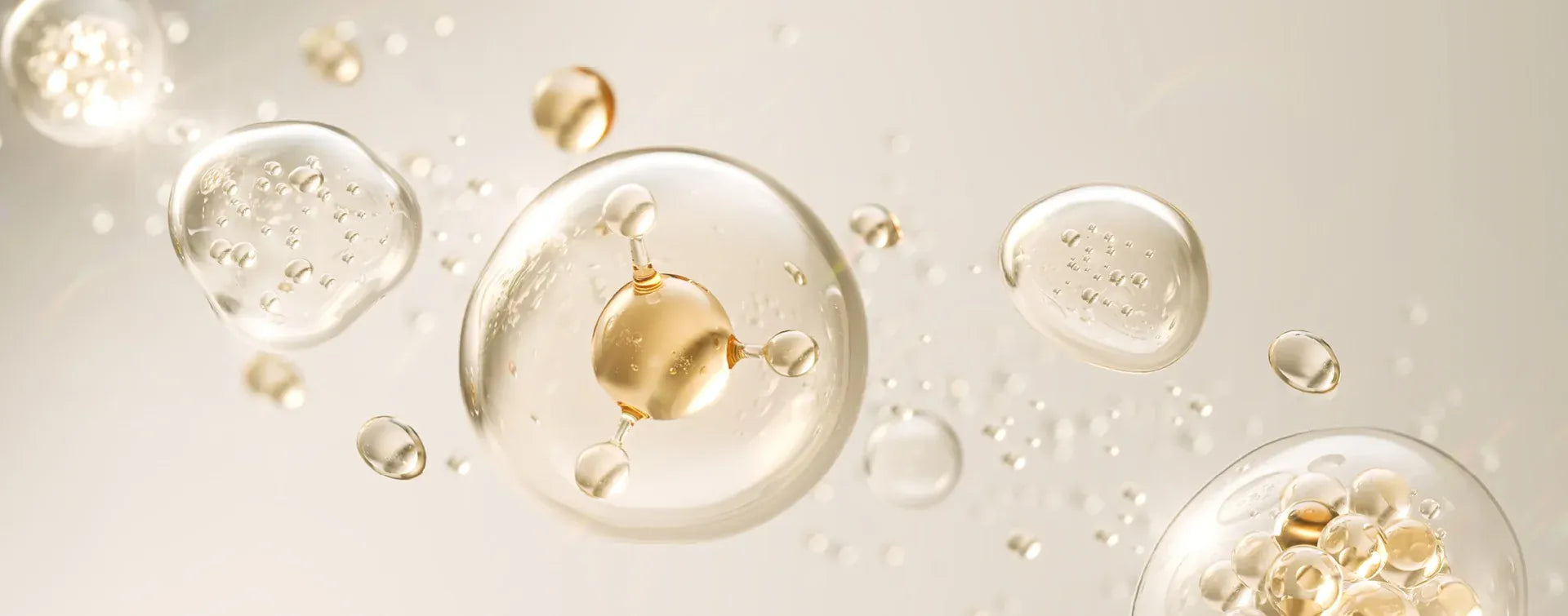 Gold droplets on a beige background