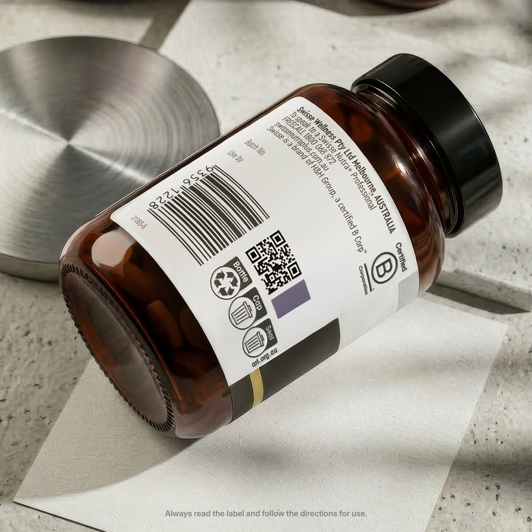 Brown glass bottle with label and QR code on a textured surface