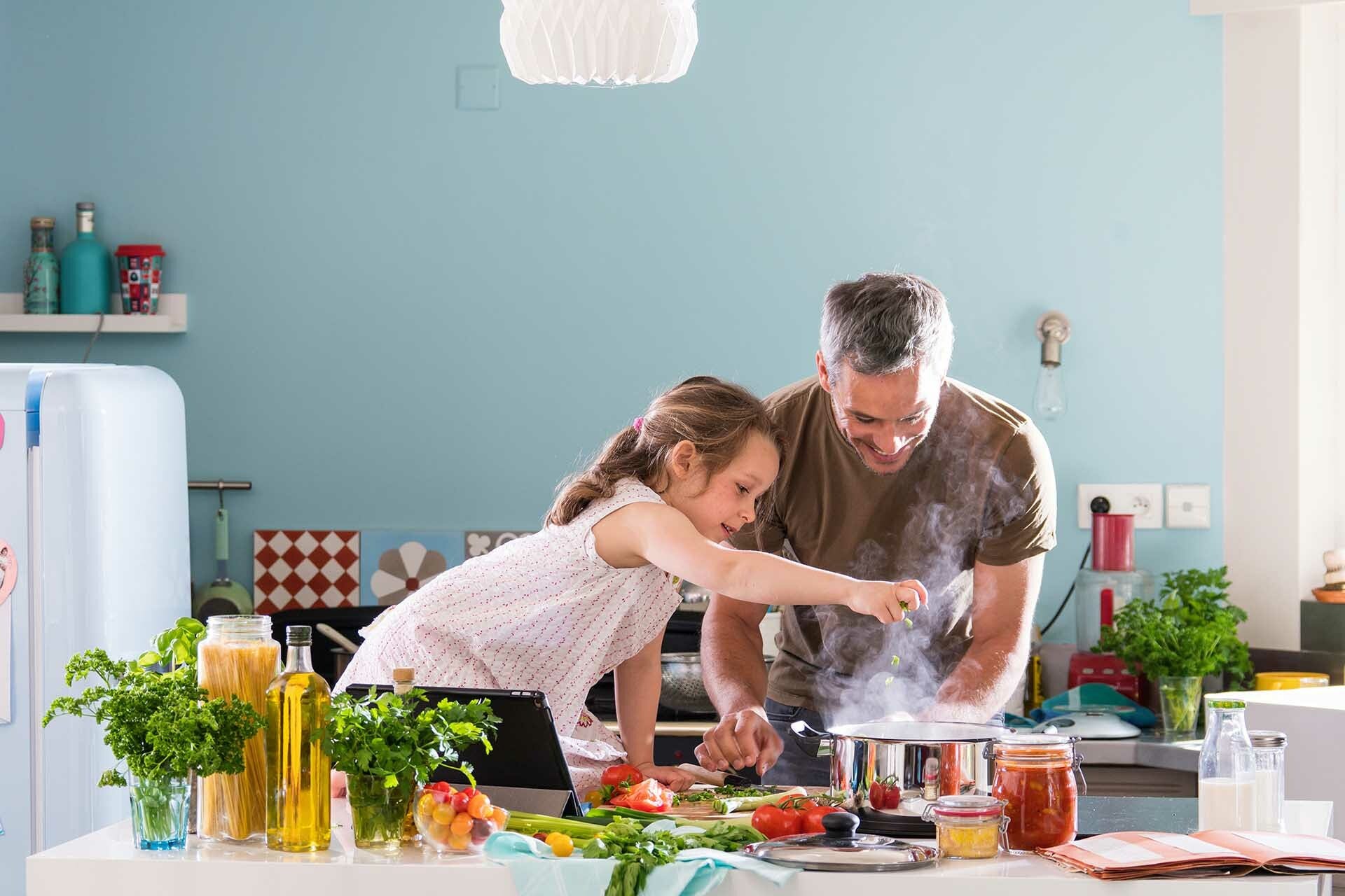 Child cooking with grownup