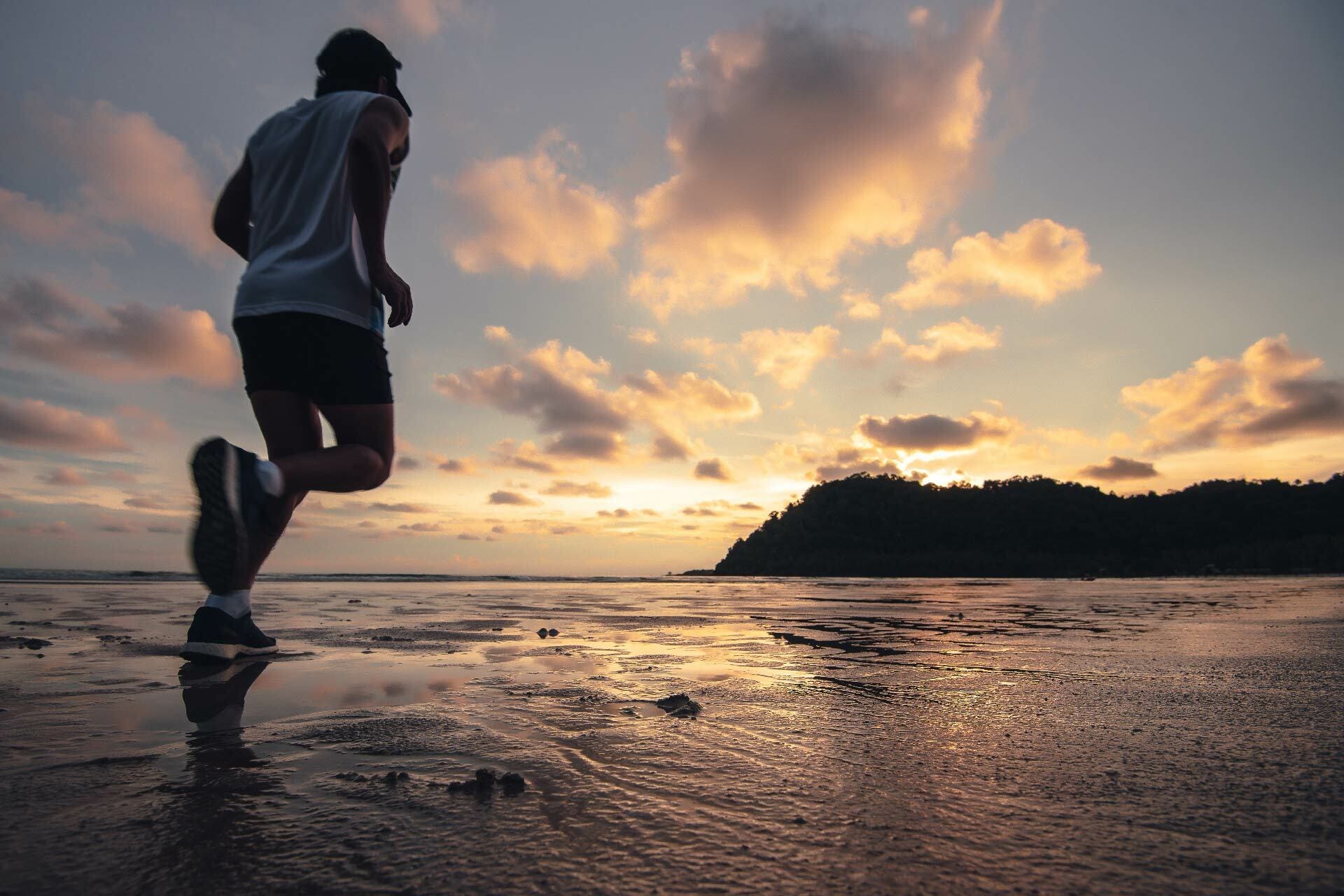 Man running at daylight savings on beach