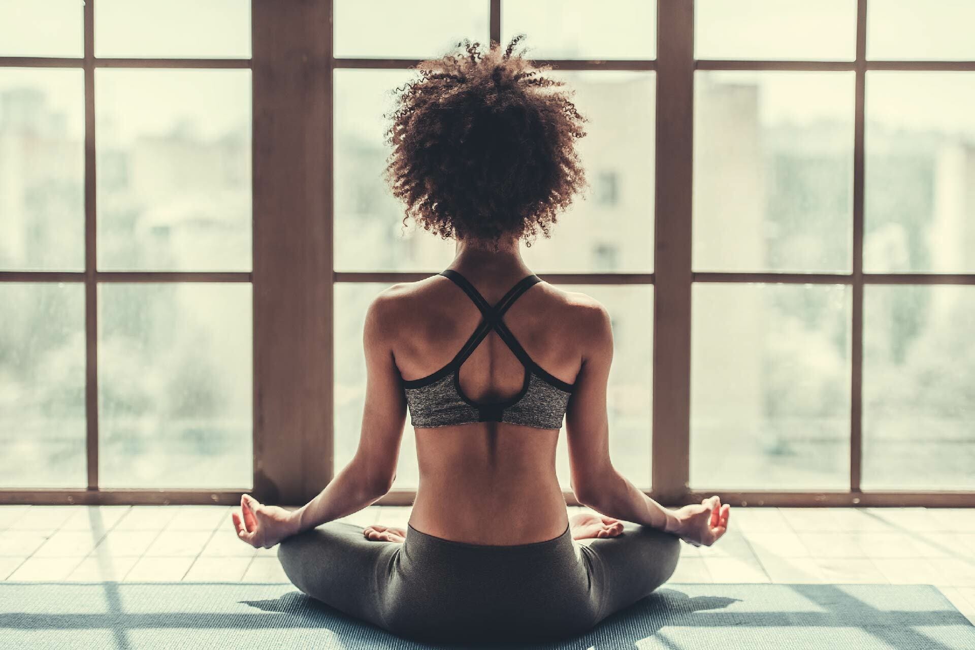 Woman meditating in yoga studio 