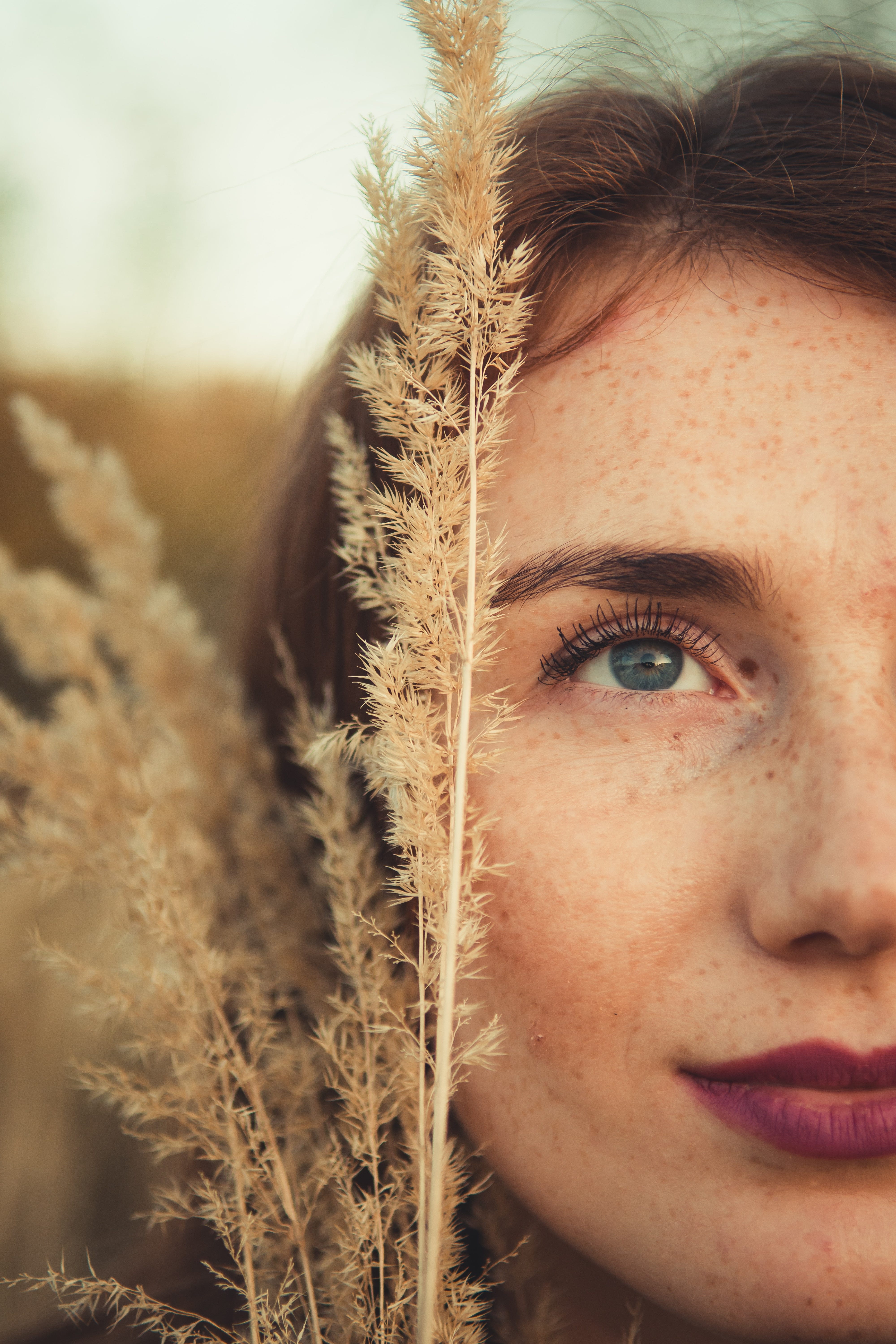 Close up of woman's face in a plant field